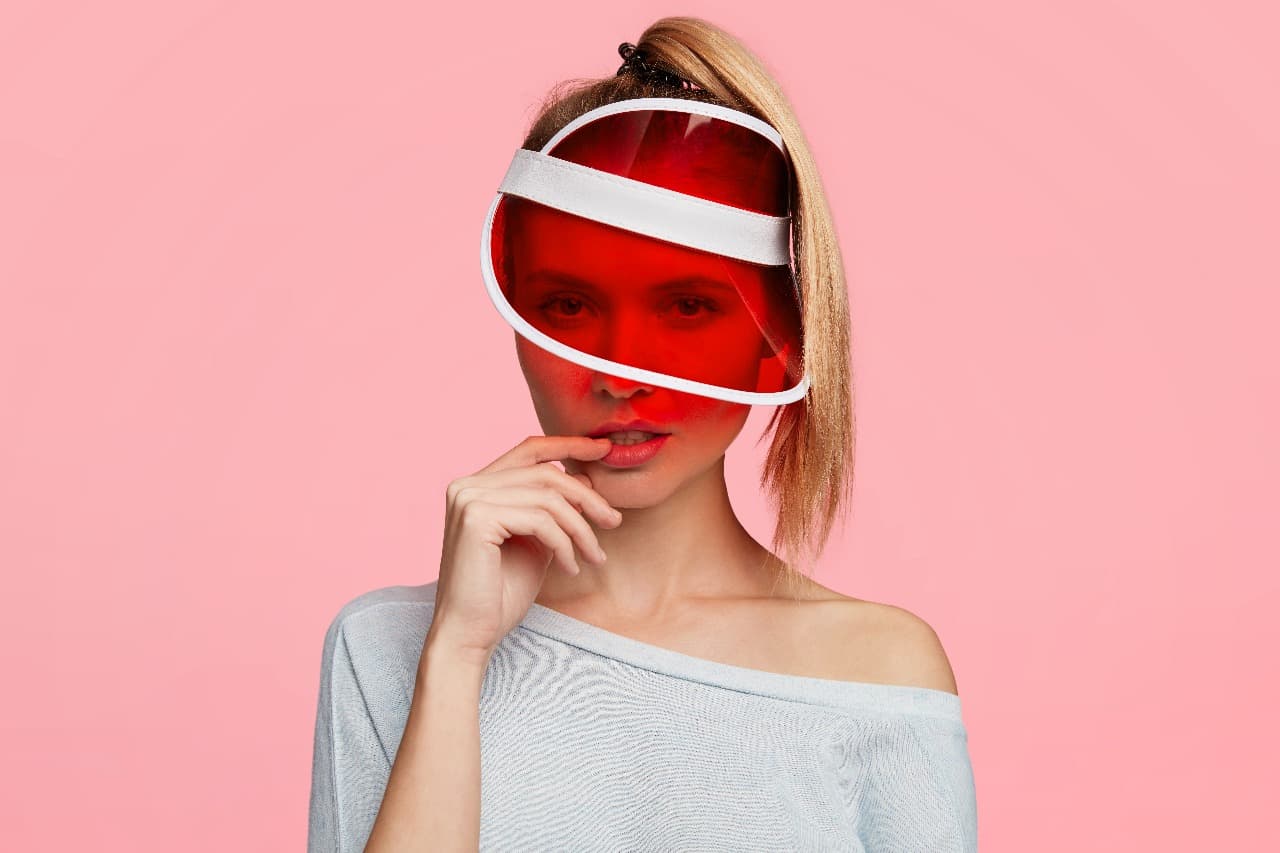 A person relaxing under the warm glow of red light therapy panels.