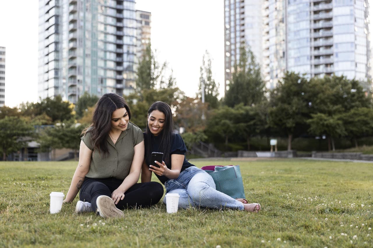 Overhead view of a modern apartment complex with a large, beautifully designed green park and playground.
